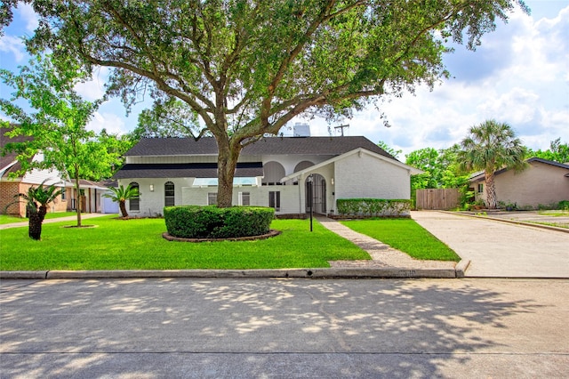 18330 Cape Bahamas Ln, Houston, TX 77058 - traditional-style home with brick siding, fence, driveway, and a front yard