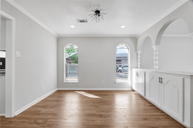 18330 Cape Bahamas Ln, Houston, TX 77058 - unfurnished dining area with a healthy amount of sunlight, ornamental molding, wood finished floors, and visible vents