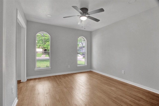 18330 Cape Bahamas Ln, Houston, TX 77058 - spare room featuring a healthy amount of sunlight, baseboards, ceiling fan, and light wood-type flooring