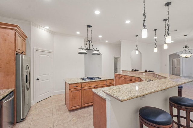 4014 N Rondelet Dr, Spring, TX 77386 - kitchen featuring brown cabinetry, crown molding, a spacious island, recessed lighting, and stainless steel appliances