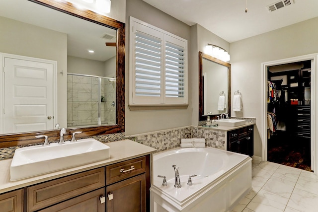 bathroom with visible vents, a sink, marble finish floor, and a stall shower