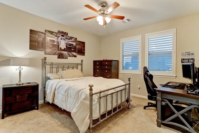 bedroom with a ceiling fan, baseboards, visible vents, and light carpet