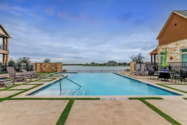 community pool featuring fence and a patio area