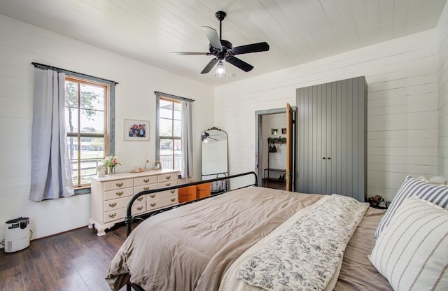14203 Cypress Creek Blvd, Cypress, TX 77429 - bedroom featuring dark wood finished floors, ceiling fan, and wood walls