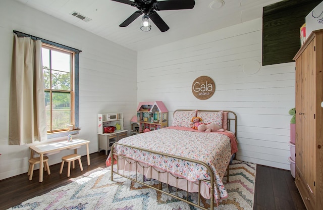 14203 Cypress Creek Blvd, Cypress, TX 77429 - bedroom with wooden walls, wood finished floors, and a ceiling fan