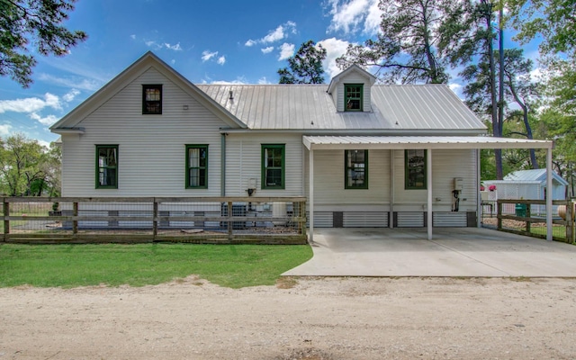 14203 Cypress Creek Blvd, Cypress, TX 77429 - view of front facade with metal roof, dirt driveway, fence, and a carport