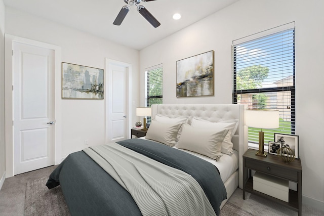 carpeted bedroom featuring baseboards and a ceiling fan