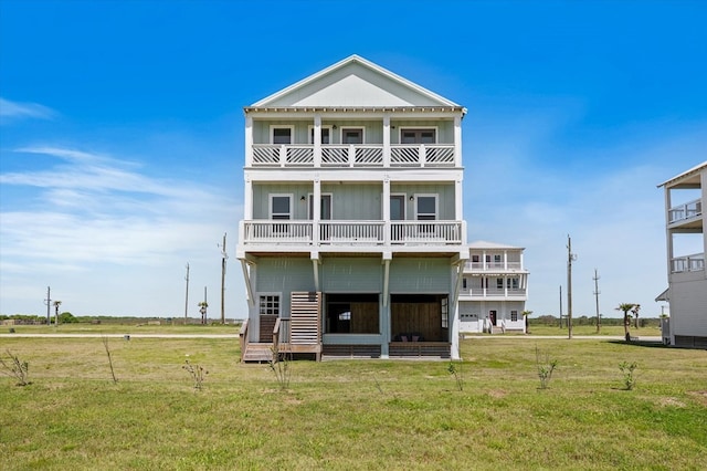 back of property with a lawn, board and batten siding, and a balcony