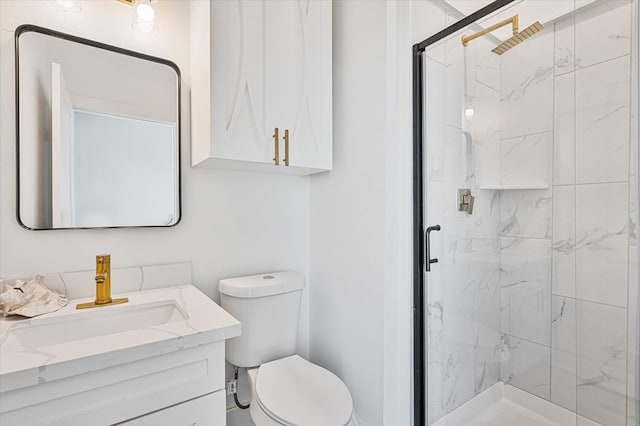 bathroom with vanity, a marble finish shower, and toilet