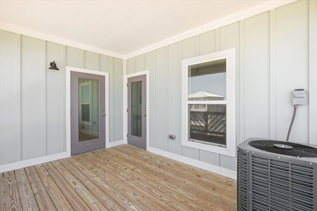 wooden deck featuring central AC unit