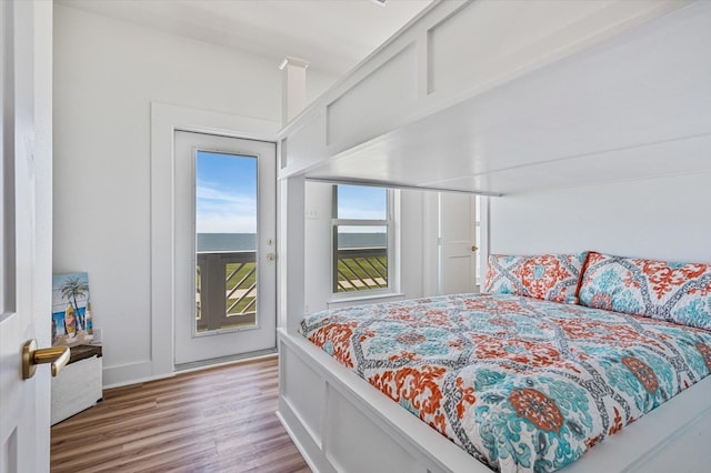 bedroom featuring access to outside and wood finished floors