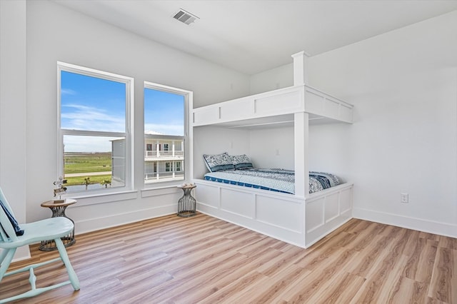 bedroom featuring visible vents, baseboards, and light wood-type flooring