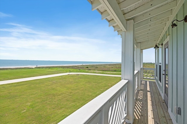 balcony featuring a view of the beach and a water view