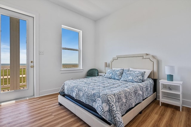 bedroom with baseboards and wood finished floors