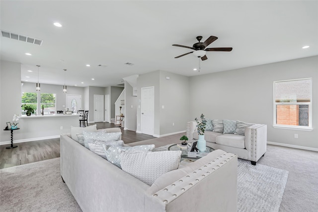 living area featuring visible vents, baseboards, stairway, recessed lighting, and a ceiling fan