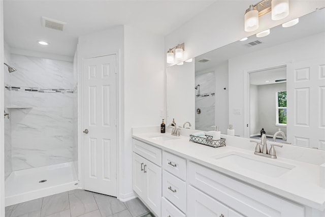 full bathroom featuring visible vents, a marble finish shower, and a sink