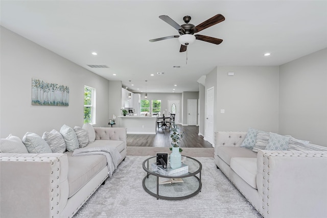 living room with ceiling fan, light wood finished floors, recessed lighting, baseboards, and visible vents