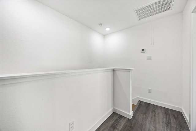 interior space with baseboards, visible vents, and dark wood-type flooring