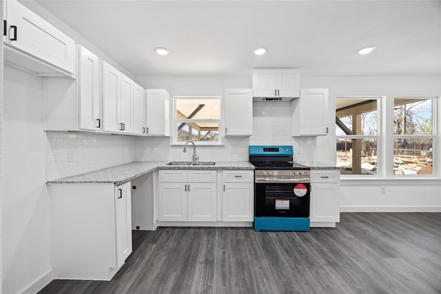 kitchen with light stone countertops, a sink, white cabinetry, baseboards, and stainless steel electric stove