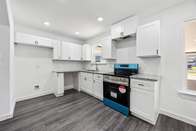 kitchen featuring stainless steel electric range oven, white cabinetry, baseboards, and a sink