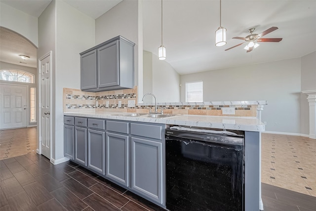 kitchen featuring ceiling fan, dishwasher, gray cabinetry, a sink, and a peninsula