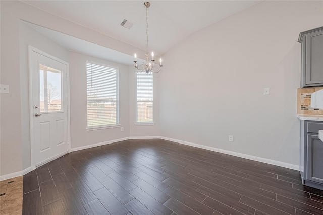 unfurnished dining area with baseboards, lofted ceiling, a chandelier, and dark wood-style floors