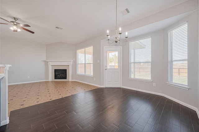 unfurnished living room featuring a glass covered fireplace, wood tiled floor, ceiling fan with notable chandelier, and visible vents
