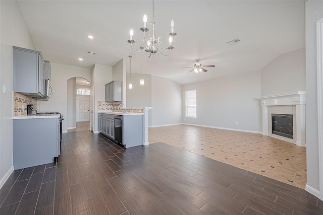 kitchen featuring visible vents, arched walkways, ceiling fan with notable chandelier, and gray cabinetry