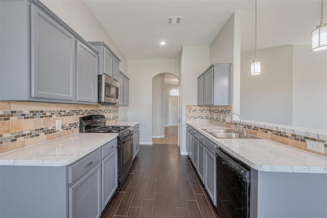 kitchen with visible vents, a sink, gray cabinets, and black appliances
