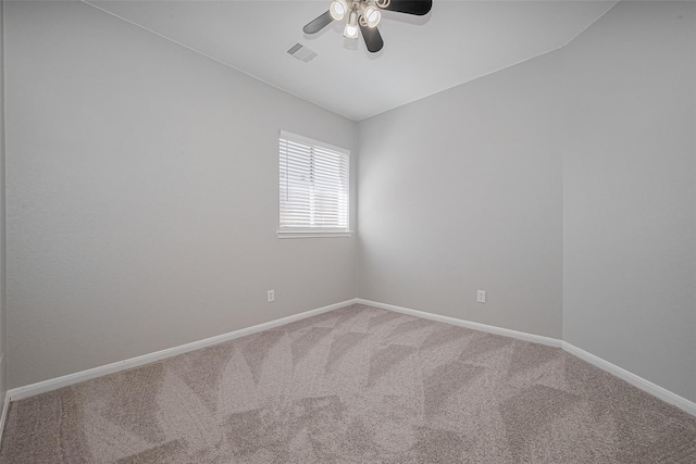 carpeted empty room with visible vents, baseboards, and ceiling fan
