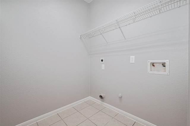 laundry room with hookup for an electric dryer, laundry area, light tile patterned floors, baseboards, and hookup for a washing machine