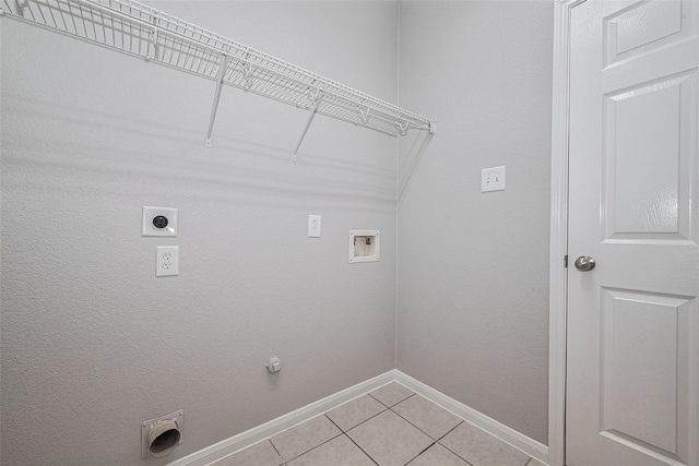 laundry area with laundry area, electric dryer hookup, light tile patterned floors, baseboards, and hookup for a washing machine
