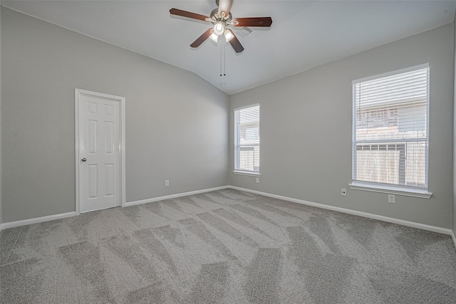 carpeted empty room with baseboards, ceiling fan, and lofted ceiling