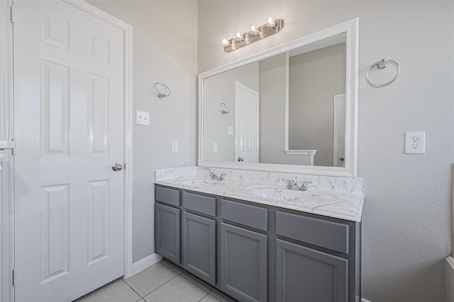 bathroom with tile patterned flooring, double vanity, and a sink