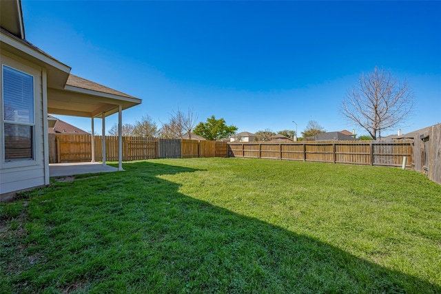 view of yard featuring a patio and a fenced backyard
