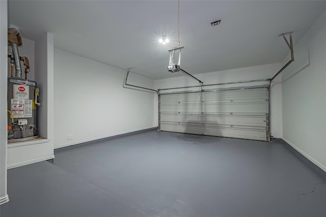 garage featuring a garage door opener and water heater