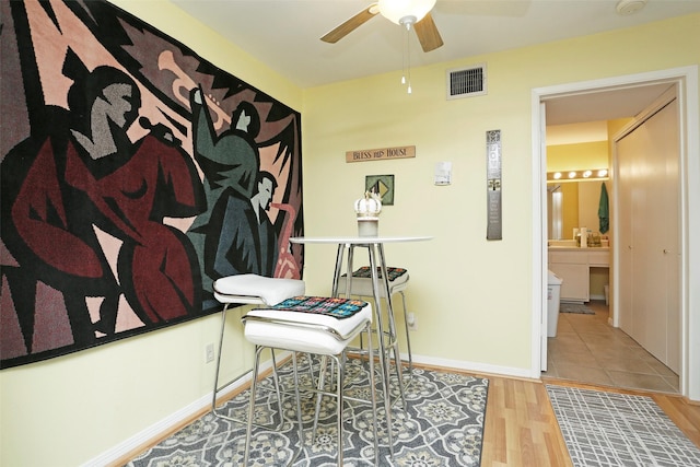 office with visible vents, baseboards, ceiling fan, and wood finished floors