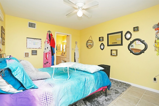 bedroom with tile patterned floors, a ceiling fan, baseboards, ensuite bathroom, and visible vents