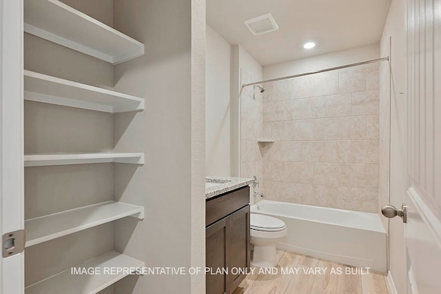 215 Rockbridge Dr, Huntsville, TX 77340 - bathroom featuring vanity, toilet, bathing tub / shower combination, wood finished floors, and visible vents