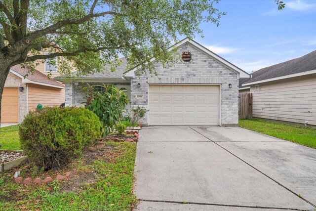 ranch-style home with brick siding, fence, and concrete driveway