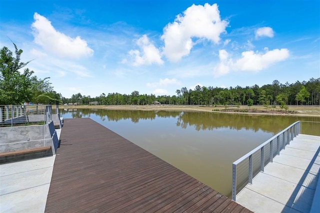 dock area featuring a water view and a view of trees