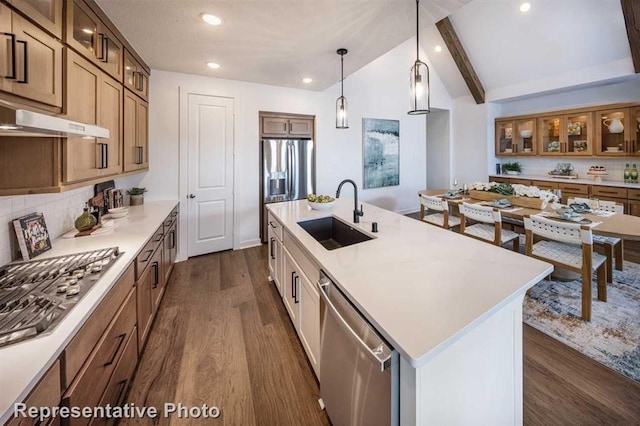 17708 Monarch Vista Ln, Conroe, TX 77302 - kitchen with stainless steel appliances, dark wood finished floors, backsplash, recessed lighting, and a center island with sink