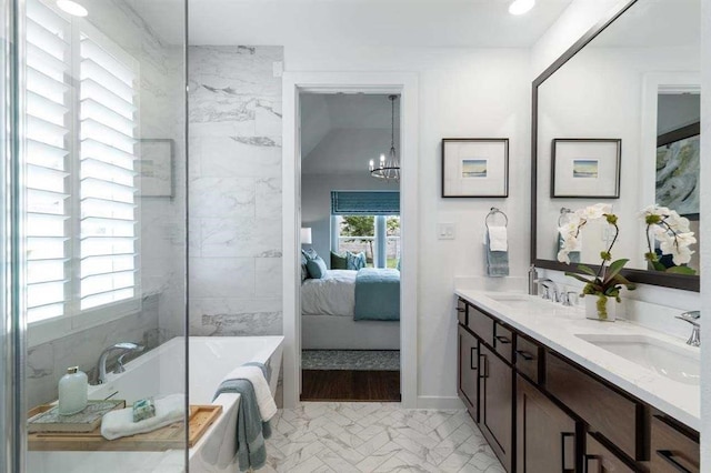 17708 Monarch Vista Ln, Conroe, TX 77302 - ensuite bathroom with a bathtub, double vanity, and a chandelier