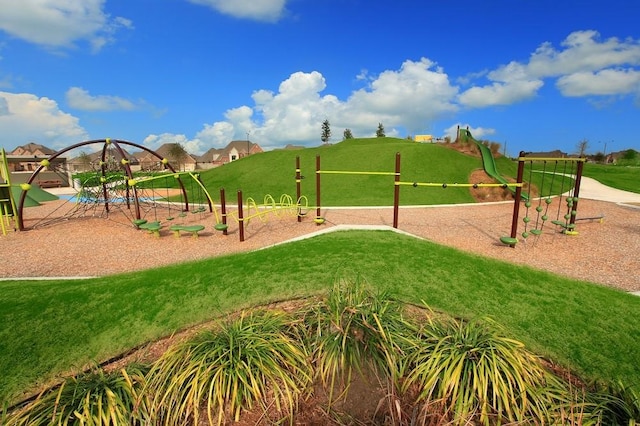 view of community featuring a lawn and playground community