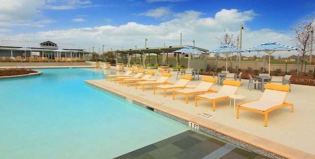 community pool featuring a patio and fence