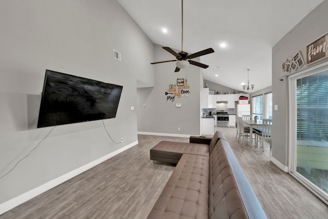 living room with light wood-style flooring, ceiling fan with notable chandelier, recessed lighting, baseboards, and visible vents