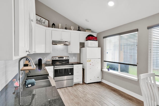 kitchen featuring backsplash, vaulted ceiling, white cabinets, under cabinet range hood, and white appliances