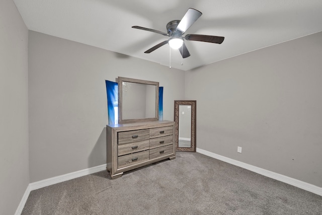 unfurnished bedroom featuring baseboards, carpet, and ceiling fan