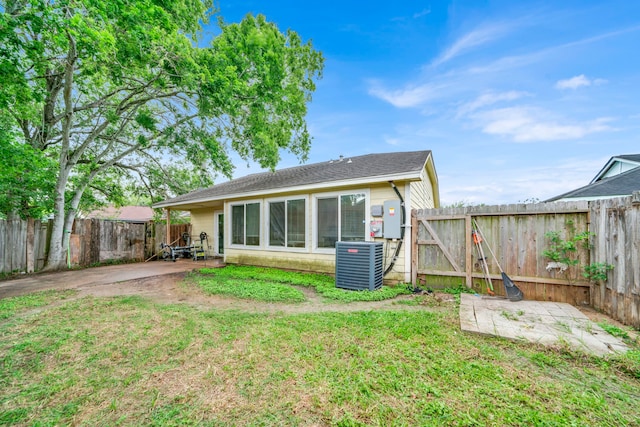 rear view of house featuring a lawn, a gate, central AC, a fenced backyard, and a patio