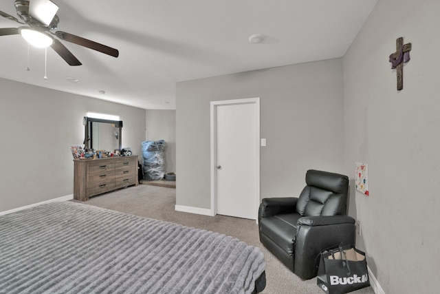 carpeted bedroom with baseboards and a ceiling fan